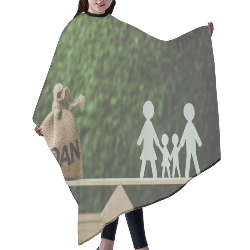 Personality  Money Bag With Loan Inscription And Paper Cut Family Balancing On See Saw On Green Background Hair Cutting Cape