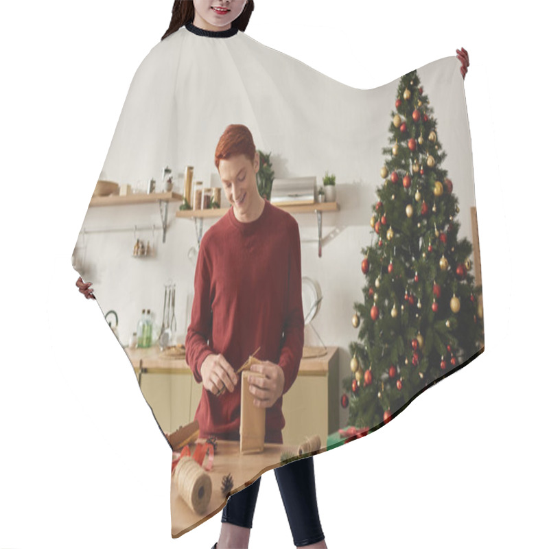 Personality  In A Cheerful Kitchen, A Young Man Wraps Holiday Gifts While Surrounded By Christmas Decor. Hair Cutting Cape