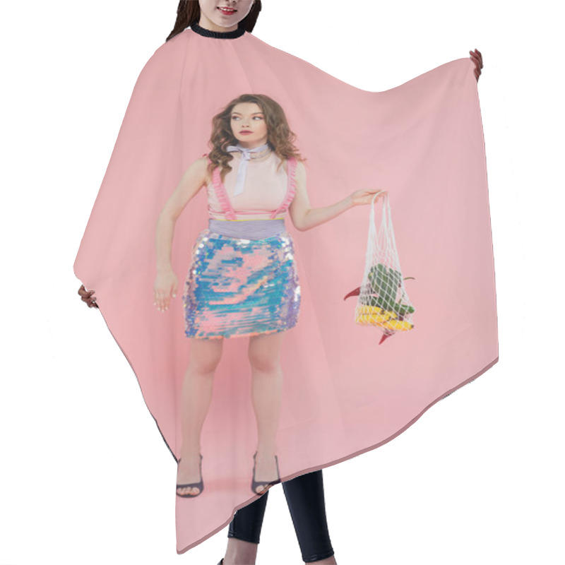 Personality  Housewife Concept, Beautiful Young Woman Posing And Gesturing Like A Doll, Holding Reusable Mesh Bag With Groceries, Trendy Wife Doing Daily House Duties, Standing On Pink Background, Eco-friendly  Hair Cutting Cape