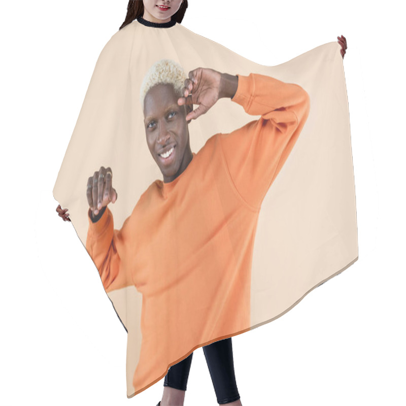 Personality  Happy African American Man In Orange Sweatshirt Looking At Camera Isolated On Beige  Hair Cutting Cape