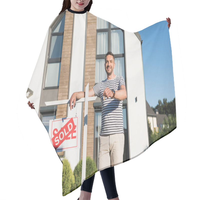 Personality  Happy Man With Key Looking At Camera While Leaning On Sign With Sold Lettering With Modern Building On Background Hair Cutting Cape