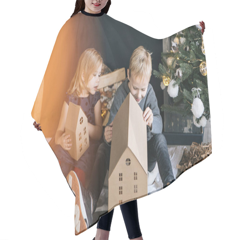 Personality  Children - A Boy And A Girl Are Sitting By The Fireplace, A New Year Tree, Playing With Cardboard Houses, A Cozy Christmas Decor And Children's Emotions Hair Cutting Cape