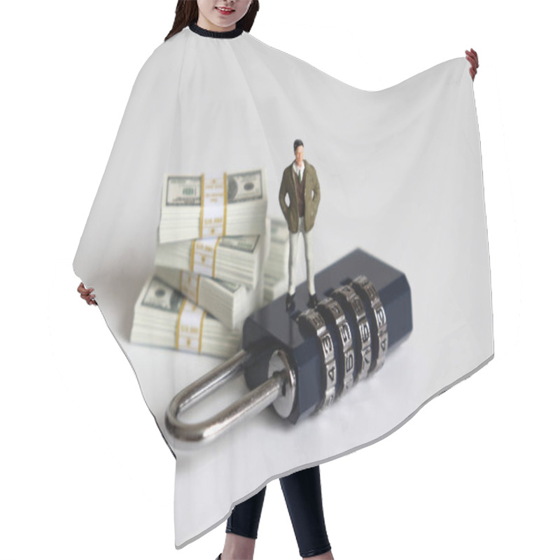 Personality  A Miniature Man Standing On A Lock And A Pile Of Bills. Hair Cutting Cape