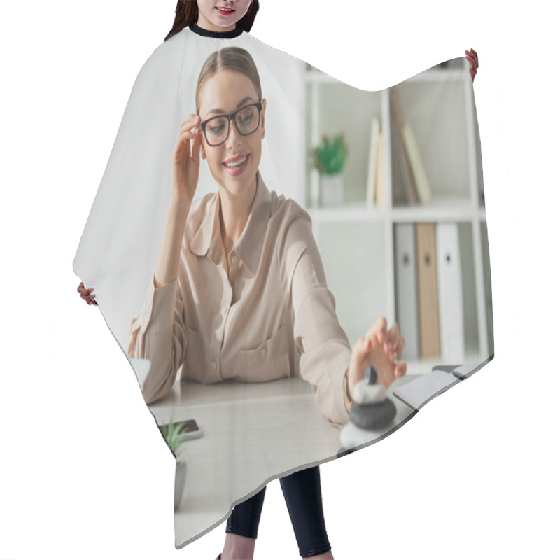 Personality  Smiling Businesswoman Sitting At Workplace With Zen Stones, Smartphone And Laptop  Hair Cutting Cape