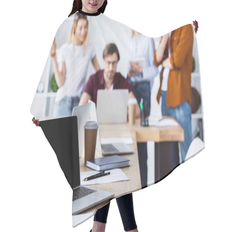 Personality  Colleagues Working On Startup Project In Office With Laptop On Foreground  Hair Cutting Cape