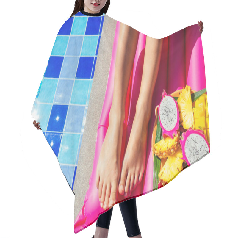 Personality  Tropical Fruits Mango, Dragon Fruit, Papaya And Pineapple On A Plate Near An Inflatable Pink Mattress And Swimming Pool And Legs Of Young Woman Close Up.summer Beach Vacation Concept Hair Cutting Cape