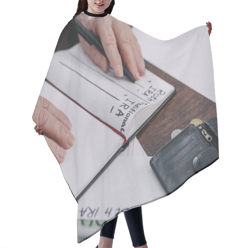 Personality  Cropped View Of Senior Woman Holding Pen Near Notebook With Roth Ira And Traditional Ira Words Hair Cutting Cape