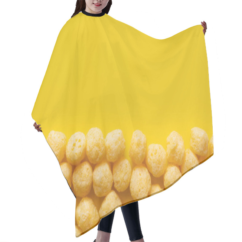 Personality  Flat Lay Of Puffed And Tasty Cheese Pops On Yellow Hair Cutting Cape