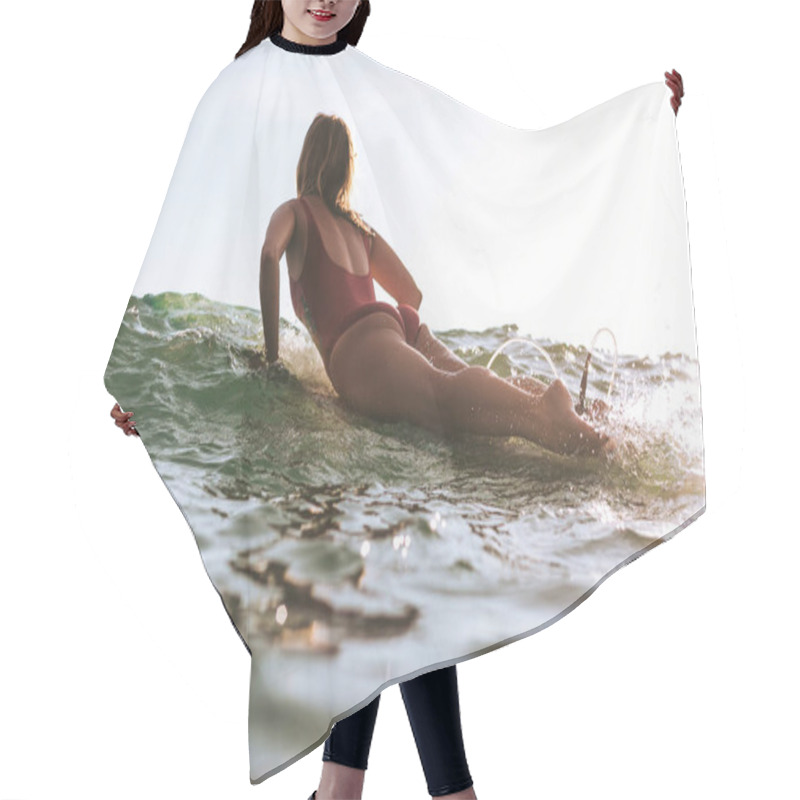 Personality  Back View Of Woman In Swimming Suit Surfing In Ocean Hair Cutting Cape