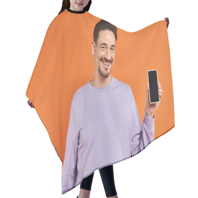 Personality  Happy Man In Glasses And Purple Sweater Holding Smartphone With Blank Screen On Orange Background Hair Cutting Cape