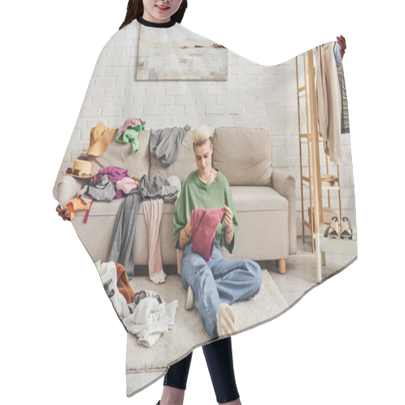 Personality  Young Tattooed Woman In Casual Clothes Sorting Thrift Store Finds While Sitting On Floor Near Couch In Modern Living Room, Sustainable Living And Mindful Consumerism Concept Hair Cutting Cape