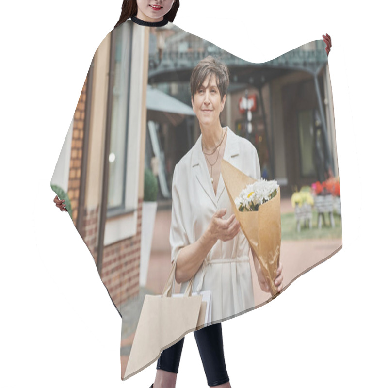 Personality  Aging Population, Pleased Senior Woman Holding Shopping Bags And Bouquet Near Outlet, Outdoors Hair Cutting Cape