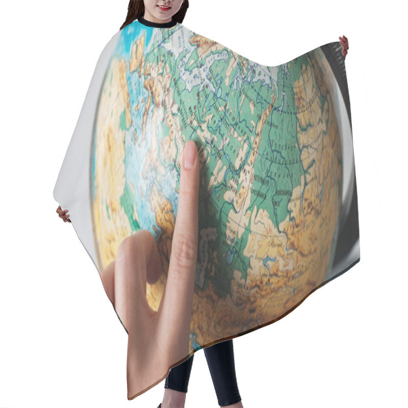 Personality  The Girl Points To A Location On The World Globe. Chooses A Place To Travel On The Globe. Hair Cutting Cape