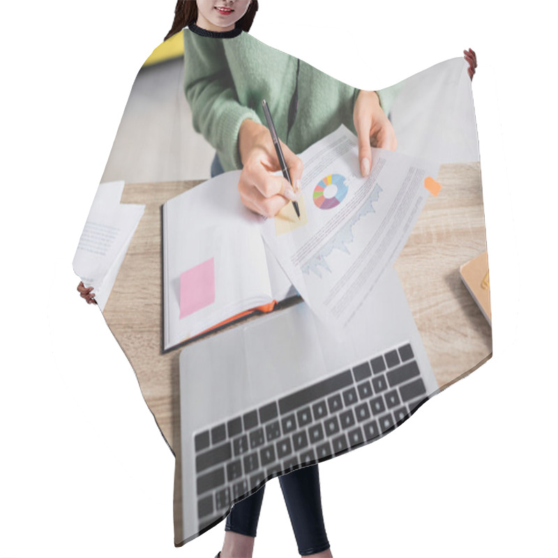 Personality  Cropped View Of Teleworker Writing On Sticky Note On Document With Charts Near Notebook And Laptop On Blurred Foreground  Hair Cutting Cape