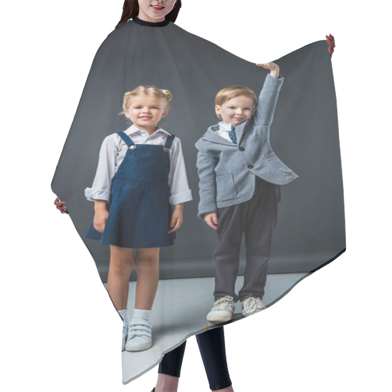 Personality  Schoolboy Standing On Books To Be Higher Near Smiling Schoolgirl Hair Cutting Cape