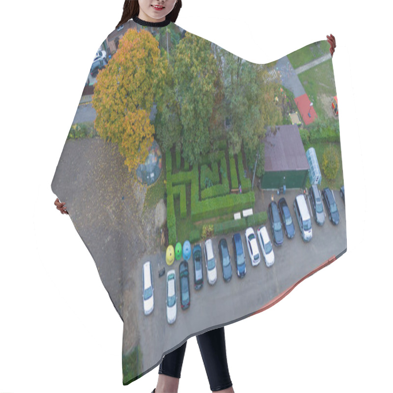 Personality  Aerial View Of A Parking Lot With Cars Lined Up Next To A Small Garden Maze And Trees. Hair Cutting Cape