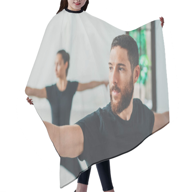 Personality  Young Sportive Man And Woman Are Practicing Yoga Exercises In The Studio. Couple Of Young Sporty People Practicing Yoga Lesson With Partner Hair Cutting Cape