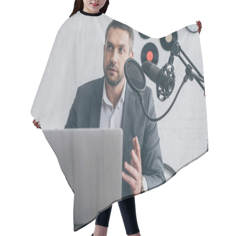 Personality  Handsome Radio Host Gesturing While Speaking In Microphone At Workplace Near Laptop  Hair Cutting Cape