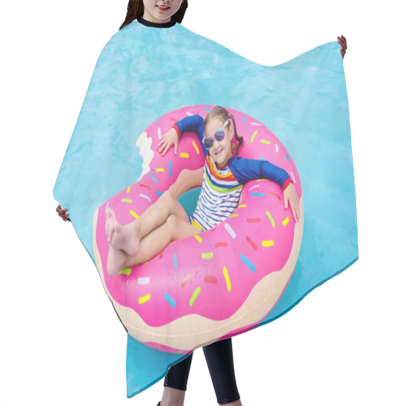 Personality  Child In Swimming Pool On Funny Inflatable Donut Float Ring. Little Girl Learning To Swim In Outdoor Pool Of Tropical Resort. Water Toys For Kids. Healthy Sport Activity For Children. Sun Protection.  Hair Cutting Cape