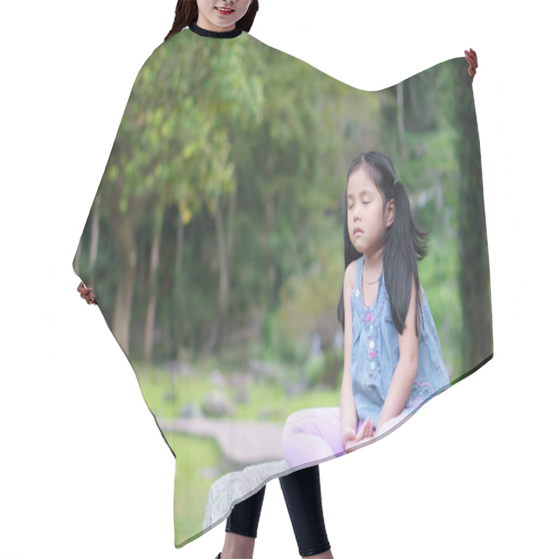 Personality  Asian Child Cute Or Kid Girl Close Eye Mindfulness Meditating With Breath And Sit On Stone Or Rock For Peace And Relax Or Yoga On Nature Green Garden And Tree At Temple Park Or Church Outdoor Hair Cutting Cape