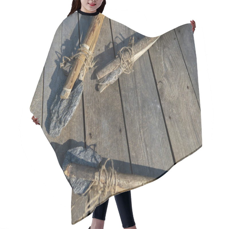 Personality  Ancient Stone Axe And Stone Spear On A Wooden Background. Hair Cutting Cape