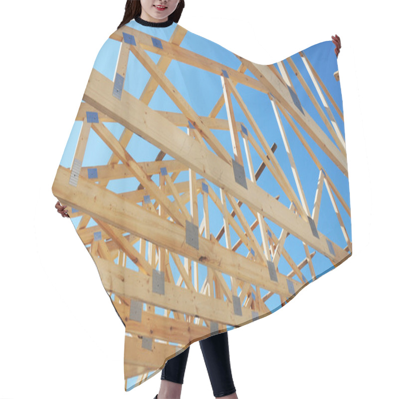 Personality  New Residential Construction Home Framing Against A Blue Sky. Roofing Construction. Hair Cutting Cape