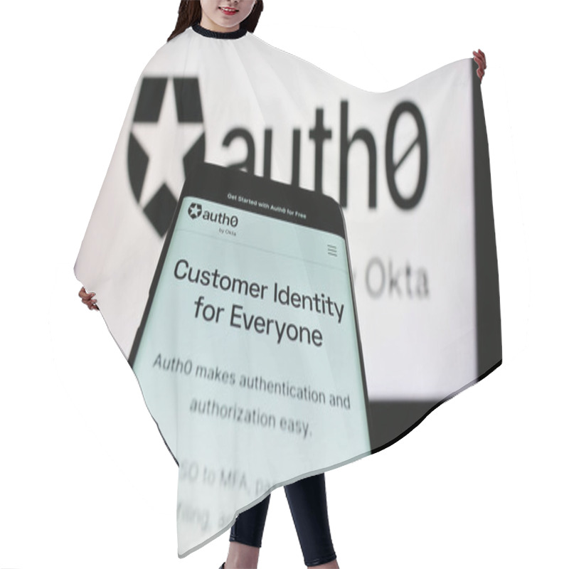 Personality  Stuttgart, Germany - 08-20-2023: Mobile Phone With Website Of US Identity Platform Company Auth0 By Okta On Screen In Front Of Business Logo. Focus On Top-left Of Phone Display. Hair Cutting Cape