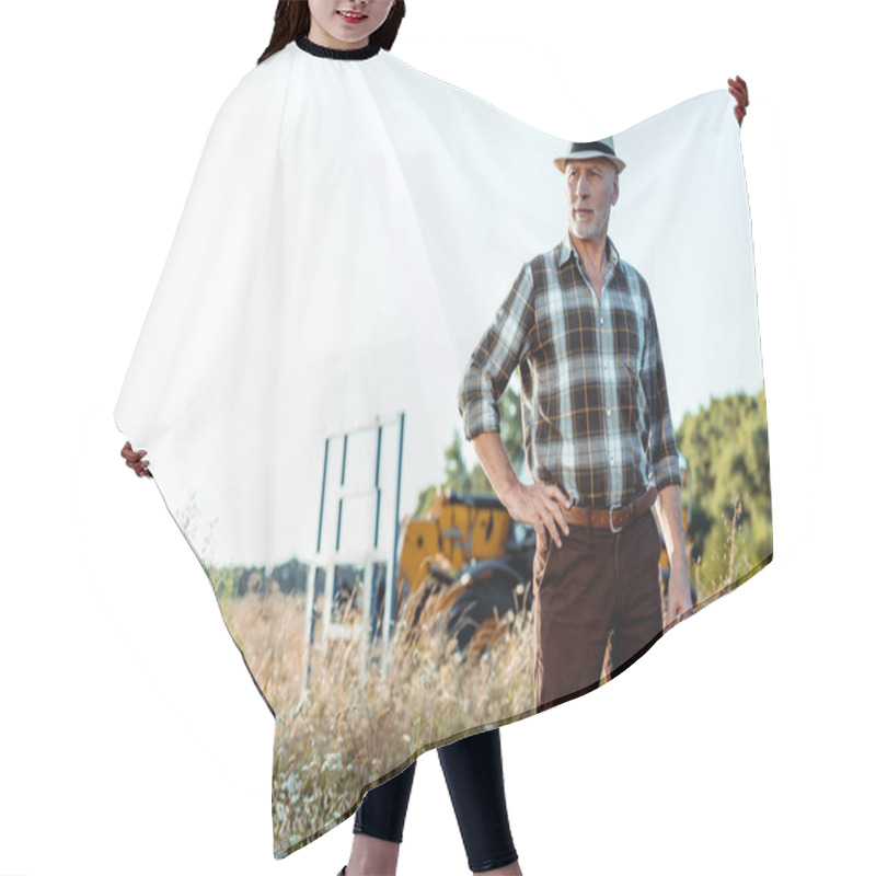 Personality  Senior Man In Straw Hat Standing With Hand On Hip Near Tractor  Hair Cutting Cape