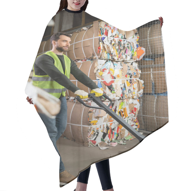 Personality  Bearded Male Worker In Protective Vest And Gloves Using Hand Pallet Truck While Standing Near Waste Paper In Garbage Sorting Center, Waste Sorting And Recycling Concept Hair Cutting Cape