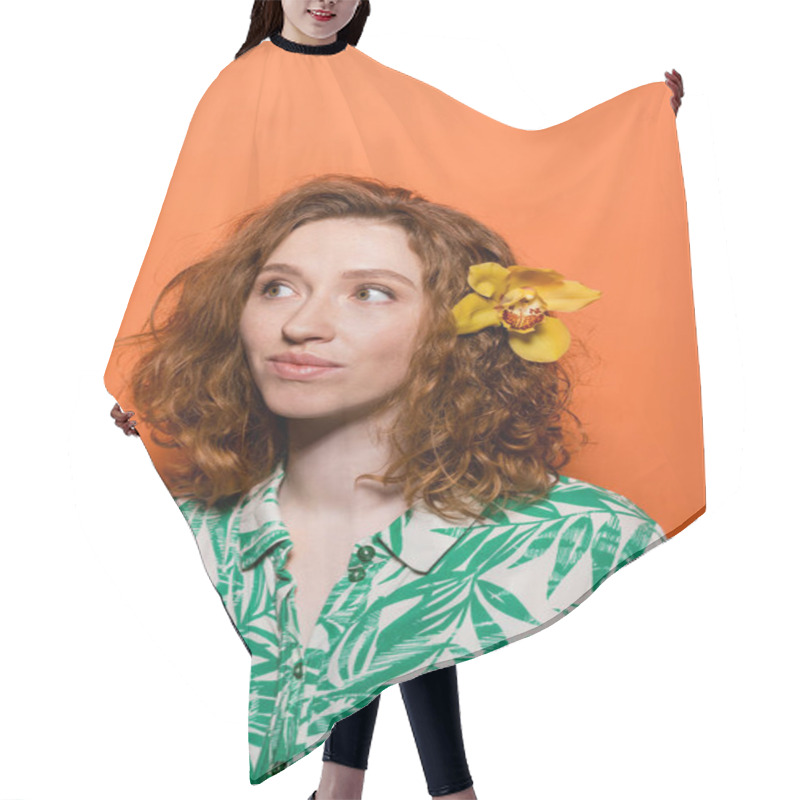 Personality  Young Redhead And Freckled Woman With Orchid Flower In Hair Wearing Blouse With Floral Print And Looking Away On Orange Background, Summer Casual And Fashion Concept, Youth Culture Hair Cutting Cape