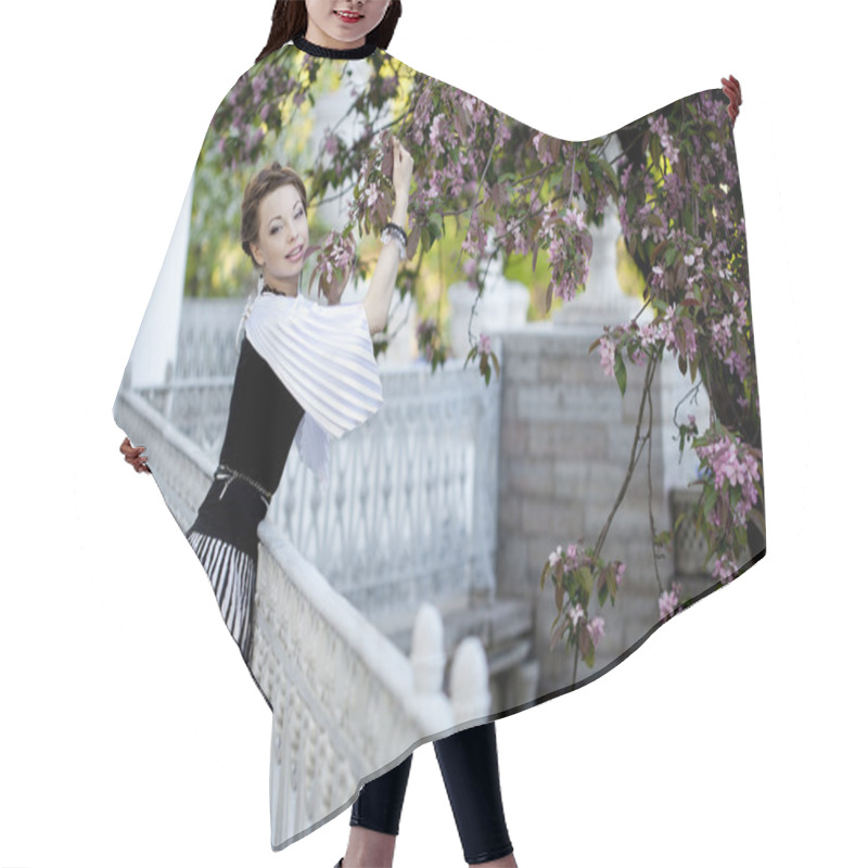 Personality  Woman With A Hair Braid In A Blossoming Park. Hair Cutting Cape