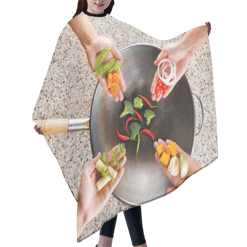 Personality  Four Hands Puts Fresh Vegetables In The Wok. Cooking Concept Hair Cutting Cape