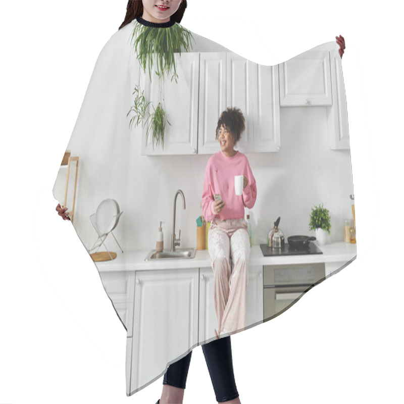 Personality  A Woman Relaxes At Home, Sipping Tea And Embracing Tranquility In Her Kitchen. Hair Cutting Cape