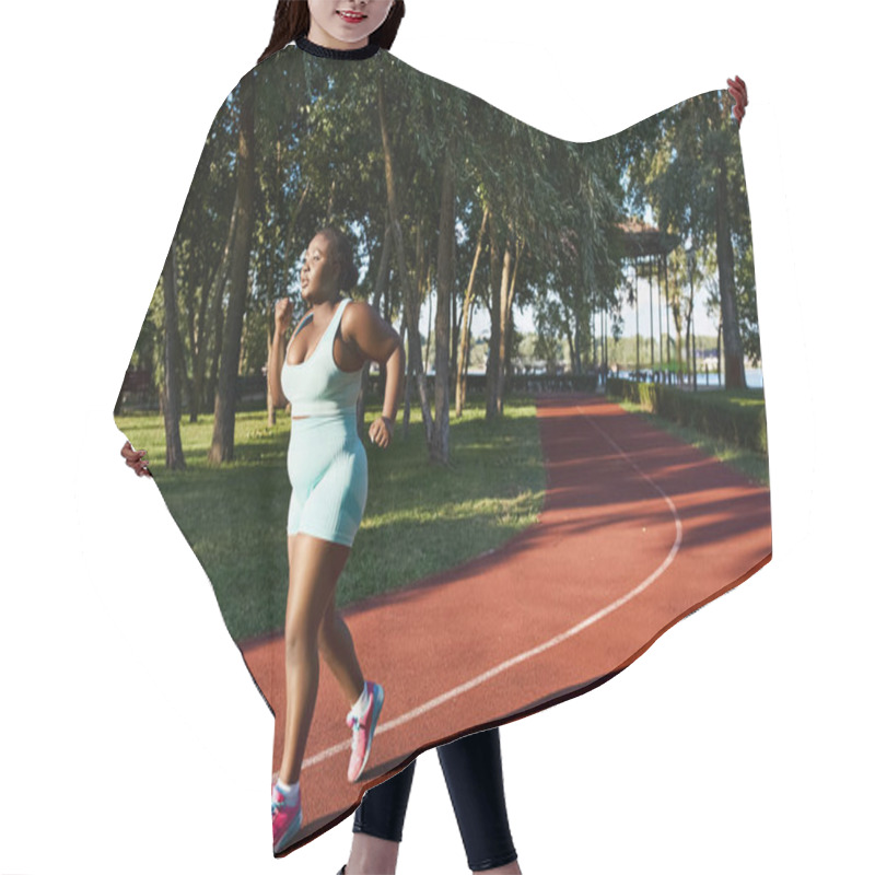 Personality  An African American Woman In Sportswear Energetically Runs Along A Track In A Lush Park Setting, Embodying Positivity And Confidence. Hair Cutting Cape