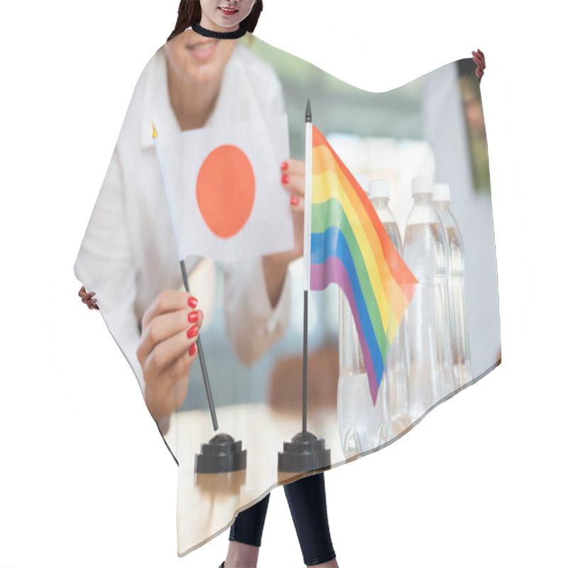 Personality  Young Woman In Business Clothes Puts Flags Of Japan And LGBT On Negotiating Table In Office Hair Cutting Cape