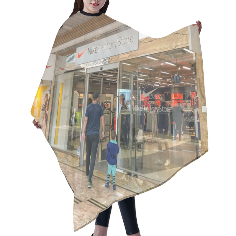 Personality  GLOUCESTER, ENGLAND - SEPTEMBER 2019: People Entering The Nike Factory Store In The Covered Shopping Centre In The Gloucester Quays Development. Hair Cutting Cape