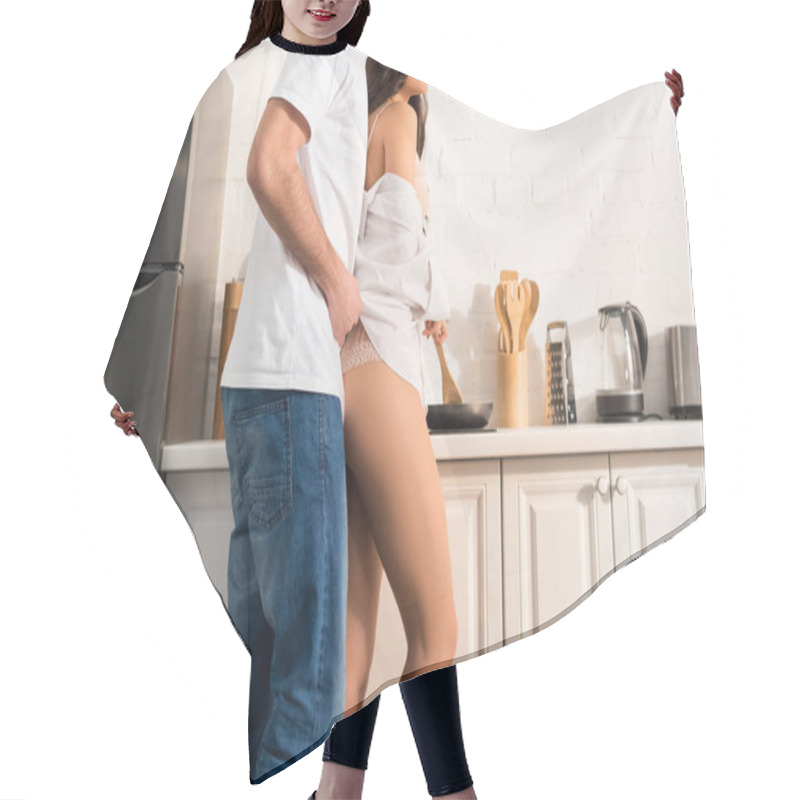 Personality  Cropped View Of Man Undressing Woman In Kitchen Hair Cutting Cape