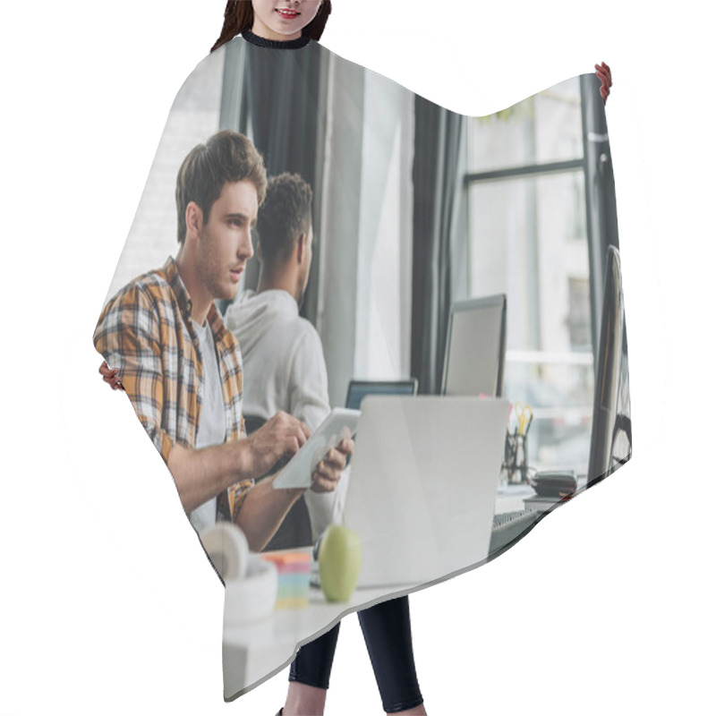 Personality  Selective Focus Of Young Programmer Working In Office Near African American Colleague Hair Cutting Cape