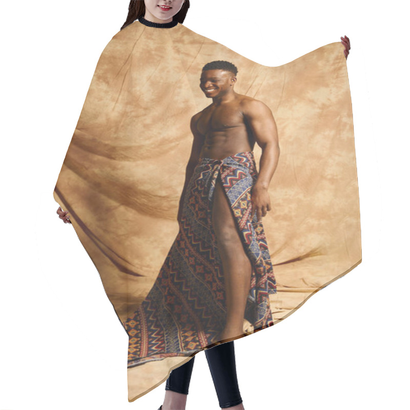 Personality  A Young Handsome African American Man Stands Confidently, Posing Topless In A Creative Studio Setting. His Vibrant Patterned Fabric Drapes Elegantly, Highlighting His Physique Against A Warm Backdrop. Hair Cutting Cape