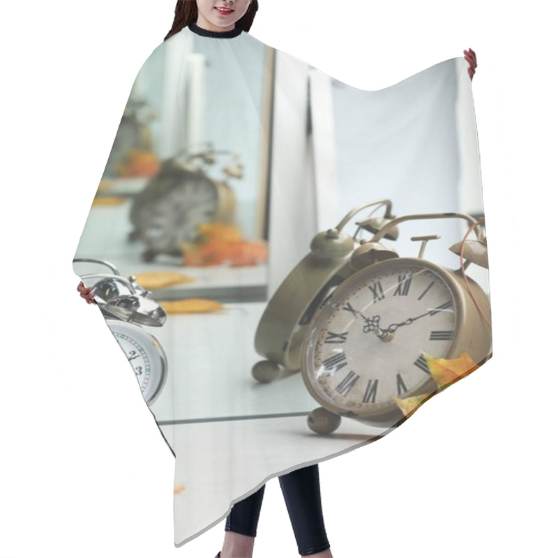 Personality  Alarm Clocks And Dry Leaves Near Mirror On White Table Hair Cutting Cape