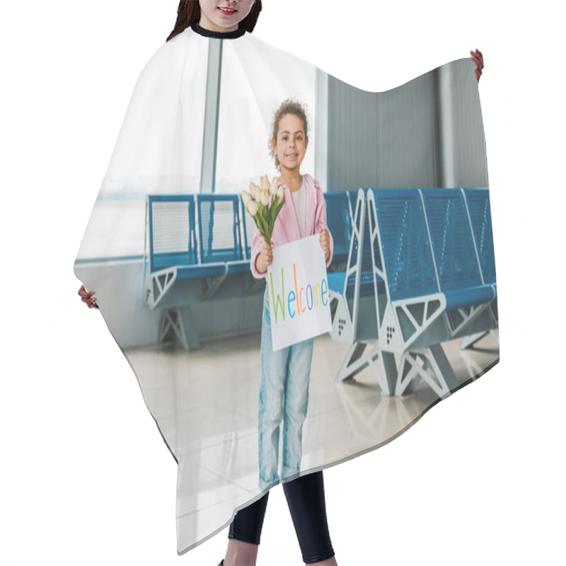 Personality  Smiling African American Kid Standing In Waiting Hall In Airport And Holding Tulips And Placard With Welcome Lettering Hair Cutting Cape