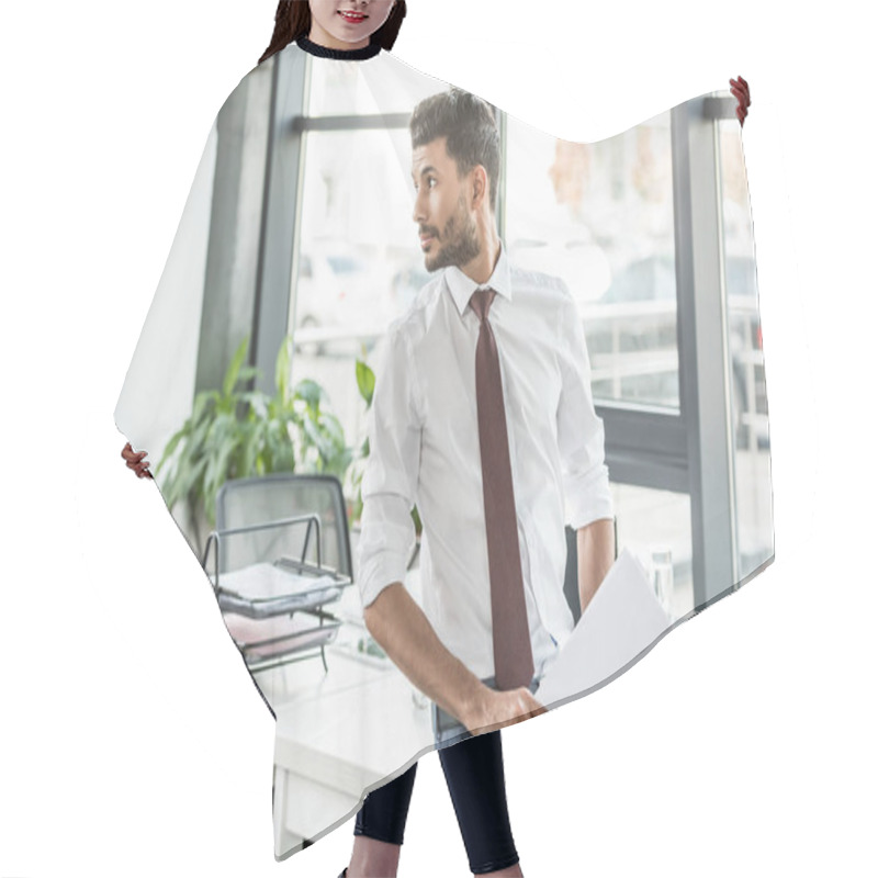 Personality  Thoughtful Businessman Holding Papers And Looking Away While Standing At Workplace Hair Cutting Cape