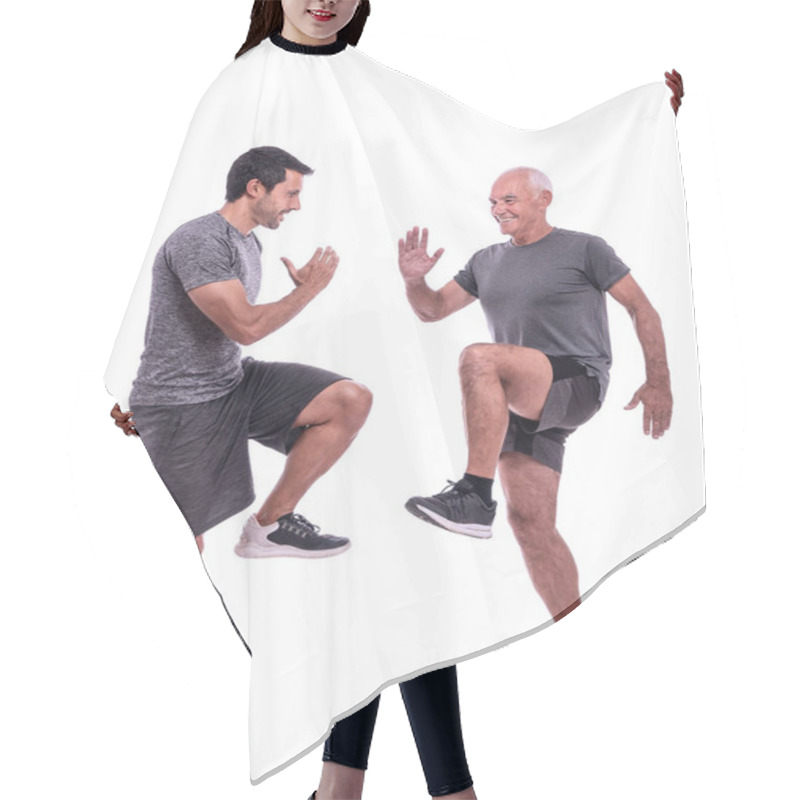 Personality  Elderly Male Client Exercising With A Fitness Trainer, Exercise Walking In Place, Steps. On A White Isolated Background. Hair Cutting Cape