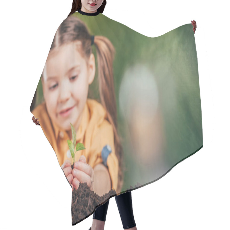 Personality  Selective Focus Of Cute Kid Planting Young Plant On Blurred Background, Earth Day Concept Hair Cutting Cape