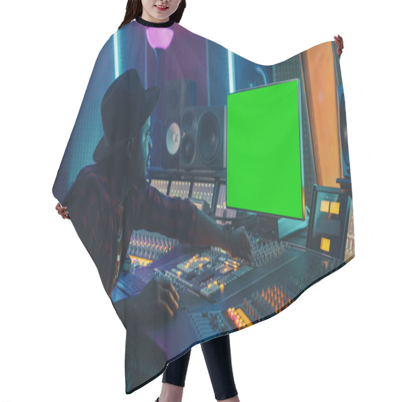 Personality  Stylish Audio Producer Working In Music Record Studio, Uses Green Screen Chroma Key Computer Display, Mixer Board Equalizer And Control Desk To Create New Hit Song. Creative Black Artist Musician Hair Cutting Cape