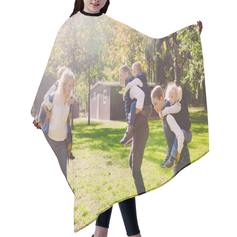 Personality  Theme Family Active Leisure Outside In Nature. Large Caucasian Family With Four Children. Mom And Dad Actively Relaxing. Enjoy Life In Park Near House On Grass. Children On Back Shoulders Roll On Top Hair Cutting Cape