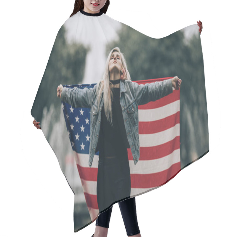 Personality  Young Woman Stands And Holds An American Flag. Hair Cutting Cape