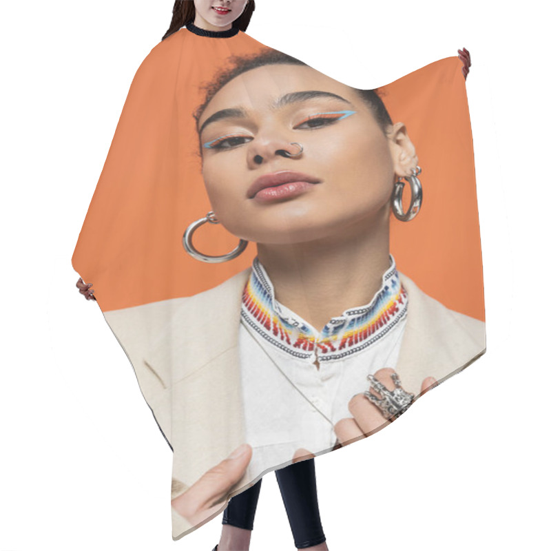 Personality  Portrait Of Stylish Fashion Model In Beige Blazer Looking At Camera On Vivid Orange Background Hair Cutting Cape