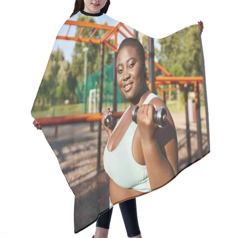 Personality  An African American Woman In Sportswear Confidently Exercises With A Dumbbell In A Lush Park, Embracing Body Positivity. Hair Cutting Cape