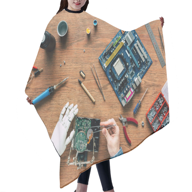 Personality  Cropped Image Of Man With Robotic Hand Repairing Hard Drive By Tweezers Hair Cutting Cape